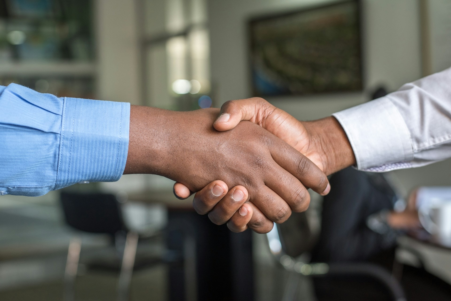 Two colleagues shaking hands in an office